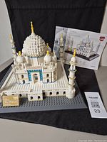 Front view of the assembled Taj Mahal model with instruction book in background.