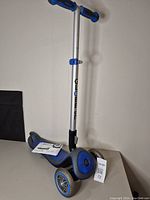 Full view of the blue and black Globber three-wheeled scooter with an adjustable handlebar in upright position.