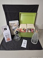 Overview of kitchen lot items showing recipe box, circle cutter set, glass dispensers, and salt grinder box