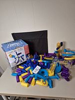 Marbleworks puzzle pieces and expansion parts spread out with box in background