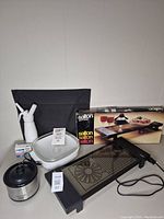 Photo showing all four items: Salton Hottray in box, Crock-Pot Little Dipper, microwave browning dish with glass lid, and whipped cream dispenser with cartridges.