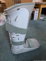 Full side view of the AirCast FP Walker boot showing plastic shell and adjustable straps.