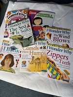 Photo showing 8 children's activity and educational books spread out on a white surface.