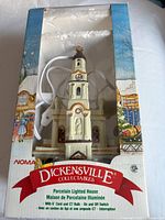 Porcelain lighted house with original box, showing white and blue packaging with winter village artwork.