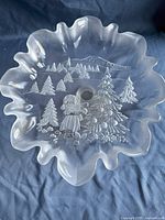 Top view of frosted glass platter with scalloped edges and etched Christmas tree with child design.