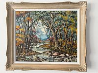 Front of the framed woodland landscape painting showing a river and trees in autumn colors.