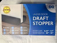 Image of packaged under door draft stopper showing product name, features, and specifications.