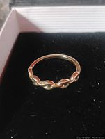 Front angled view of the 10k gold puff anchor link ring in black velvet box.