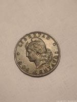 Close-up of 1889 Dos Centavos coin showing obverse with Liberty bust and clear inscription.