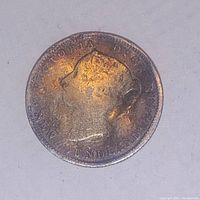 Close-up photo of the obverse side of the 1896 Newfoundland 5 cent coin showing Queen Victoria with tarnishing and warping.