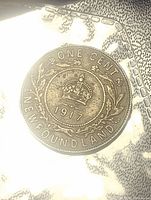 Reverse side of 1917 Newfoundland large cent coin featuring crown, date 1917, surrounded by wreath and inscription ONE CENT NEWFOUNDLAND.