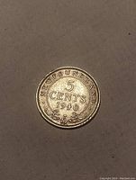 Reverse side of 1940 Newfoundland 5 Cent silver coin showing denomination and date with decorative elements.