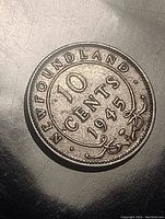 Obverse of 1945 Newfoundland 10 cents silver coin showing denomination and year with 'NEWFOUNDLAND' text and floral decoration.