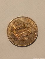 Front side of the 1954 England half penny coin featuring a sailing ship and the text 'HALF PENNY 1954'