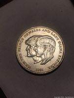 Obverse side of the coin showing the profiles of Prince Charles and Lady Diana Spencer with inscriptions and year 1981.