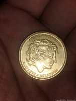 Obverse side of the coin showing Alexander the Great's profile with Greek text.