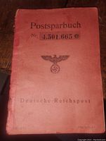 Front red cover of the savings book with Nazi eagle and swastika and serial number.