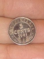 Close-up image of the obverse side of a 1941 Newfoundland 5 cent silver coin showing 'NEWFOUNDLAND 5 CENTS 1941' with ornate detail.