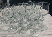 Photo showing multiple Zwiesel Kristallglas Regina stemware glasses of varied sizes grouped on a marble surface, highlighting clear lead crystal, faceted stems, and bowl shapes.