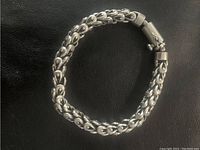 Image showing the full bracelet with secure clasp on a black background.