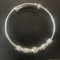 Top view of a .925 sterling silver cuff bracelet bangle with decorative beaded accents on a black background.