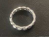 Top view of the silver braided infinity ring showing the circular pattern and braided details