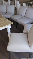 Six chairs grouped around dining table corner
