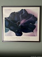 Front view of the Georgia O'Keeffe floral print in metal frame hanging on a wall.