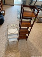 Both shelving units together showing wood and wicker materials, relative size and shelf count.