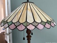 Close-up of scalloped multicolor stained glass shade