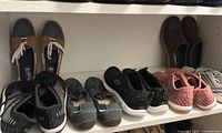 Photo showing six pairs of women's sneakers and slip-ons on a shelf with various brands including Sketchers, Clarks, Merrell.