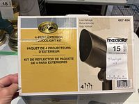 Front of box showing Hampton Bay branding and product title '4-Pack Exterior Floodlight Kit'.