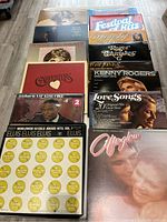 Top view of one set of assorted vintage vinyl record album covers featuring various artists from pop and country genres