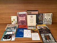 View of all calligraphy books and paper supplies laid out on a wooden table, showing titles and packaging.