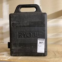 Closed black Ryobi case with handle and embossed logo