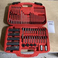 Photo of open red plastic SKIL branded case showing drill and drive bits organized in molded slots within the case.