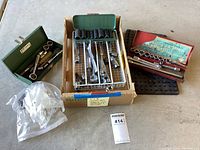 Overview of three vintage socket sets in various cases and trays with adapters and ratchets.