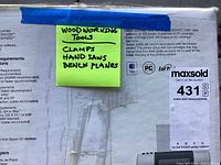 Photo of the lot's label describing woodworking tools including clamps, hand saws, bench planes