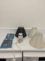 Group photo showing all items in the lot - owl lamp, three lamp shades, two blue picture frames