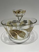 Photo of vintage chip and dip set showing clear glass bowls with gold and black leaf patterns.