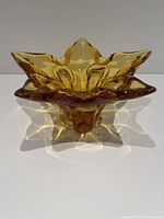 Front and top view of amber glass bowl showing smooth translucent glass and star-shaped 5-point design.