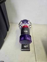 Dyson SV25 handheld vacuum head on table from front view