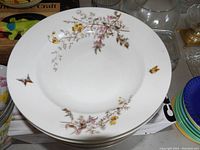 Large ceramic plate with floral branches and bird decoration
