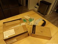 Photo showing boxed garlic and brie baker with lid and decorator bottle set box on wooden table.