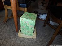 Two stationary boxes stacked; top box with floral pattern, bottom with beige 'Dear Sweet Child' design.