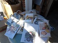 Multiple craft kits spread on a table with visible titles and materials for seasonal and creative projects