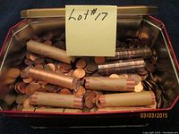 Metal container filled with approximately 10 pounds of pennies in paper rolls and loose, as per seller description