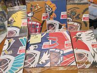 Photo of all 8 sealed goalie mask panels standing upright showing artwork and packaging