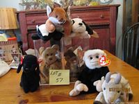 Photo showing 8 Beanie Baby bears arranged on table, several different colors and a fox plush included. Bears in good condition with tags.