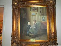 Front view of large ornate gilded vintage frame containing a signed print of two children seated indoors, showing full artwork and frame dimensions.